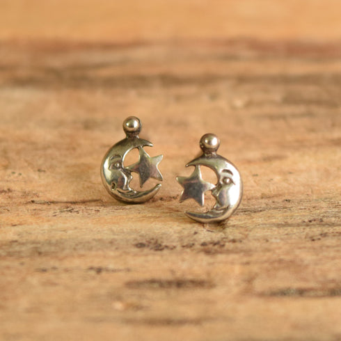 Moon and star stud earrings sterling silver on wooden background
