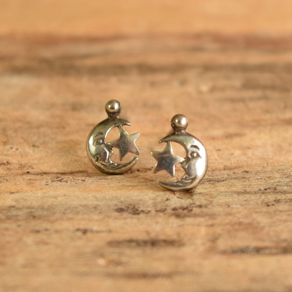 Moon and star stud earrings sterling silver on wooden background