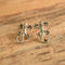 Sterling silver lizard gecko earrings on wood background