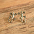 Sterling silver lizard gecko earrings on wood background