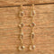 Long clear crystal drop earrings on wood background