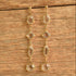 Long clear crystal drop earrings on wood background