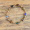 Gold filled carved gemstone scarab bracelet on wooden background