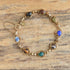 Gold filled carved gemstone scarab bracelet on wooden background