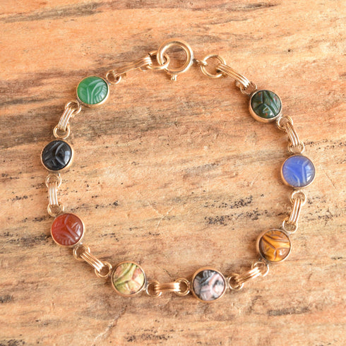 round dainty scarab bracelet vintage gold filled - displayed on wood background