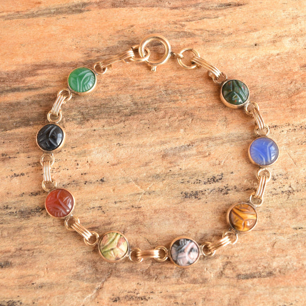 round dainty scarab bracelet vintage gold filled - displayed on wood background