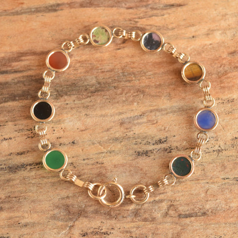 underside of vintage scarab bracelet on wood background