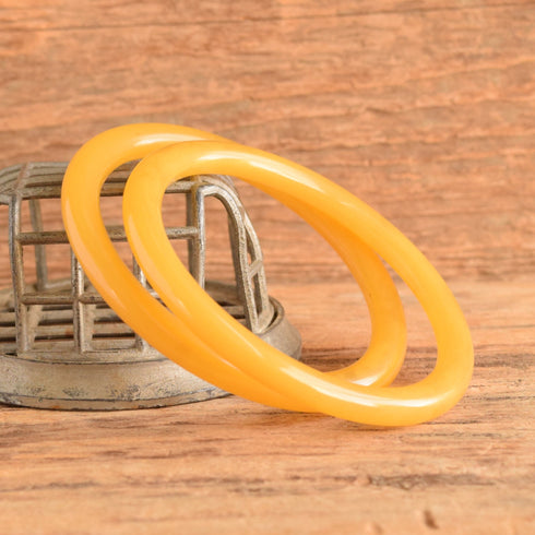 Yellow pair of rounded bakelite spacer bangles