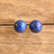 Lapis Lazuli ball stud earrings on wooden background