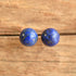 Lapis Lazuli ball stud earrings on wooden background