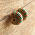 Colorful striped earrings on a wooden surface