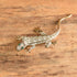 Green Eyed Lizard Brooch on wooden background