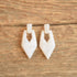 80s white marbled vintage earrings door knocker style on wood