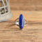 Long Blue Lapis Sterling Silver Ring Size 9 on wood backdrop