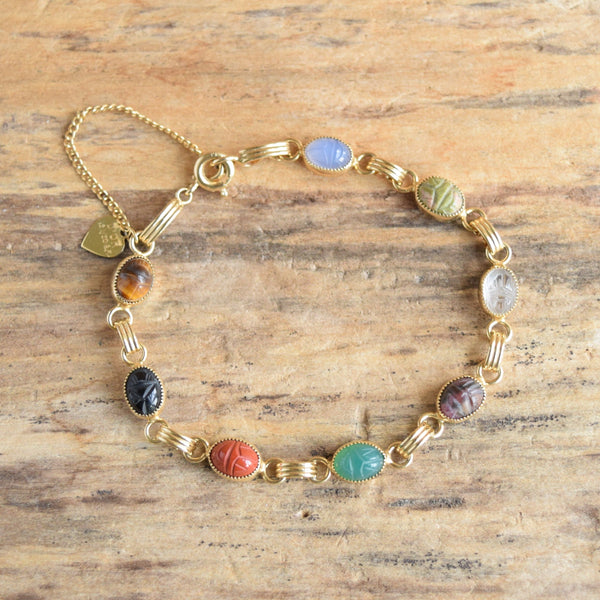small scarab gemstone bracelet on wooden background - gold filled