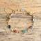small scarab gemstone bracelet on wooden background - gold filled