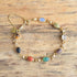 small scarab gemstone bracelet on wooden background - gold filled
