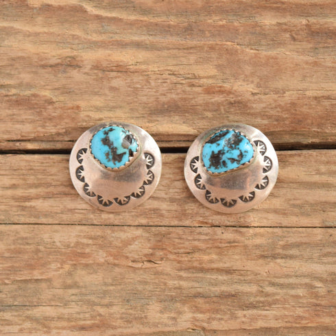 Southwestern stamped turquoise nugget earrings on wood