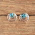 Southwestern stamped turquoise nugget earrings on wood