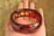 Prystal Bakelite - Reverse Carved and Painted Fruit and Vegetables Red Bakelite Bangle