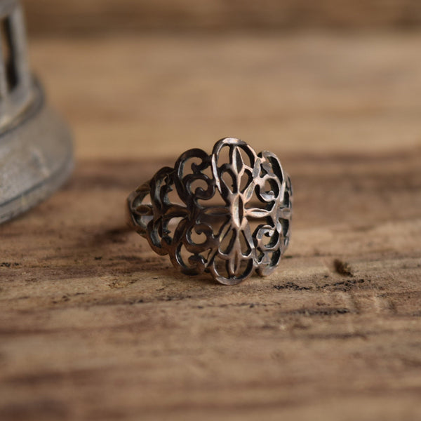 sterling silver filigree ringon wooden background